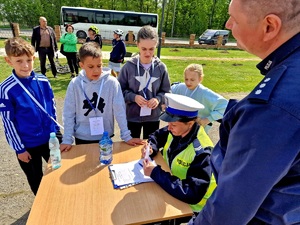 policjantka dająca kartki uczniom